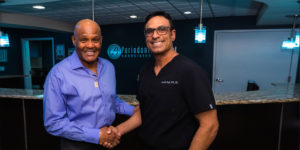 dr singh with john shaking hands after dental procedure